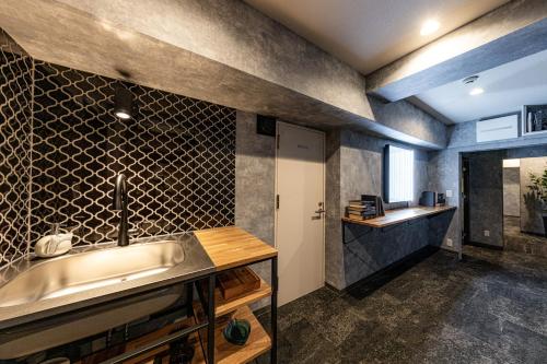 a kitchen with a sink and a counter at Inn The Omotesando in Tokyo