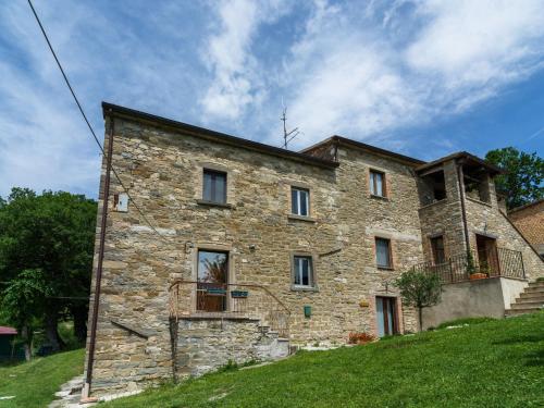 a stone building on a grassy hill with a sky at Beautiful Apartment in Sestino with Garden in Sestino