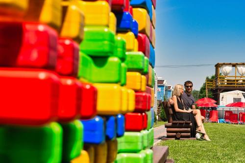 a couple sitting in a chair in front of a lego wall at Holiday Park Zator in Zator