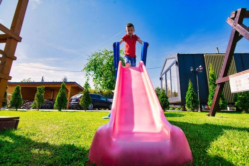 a boy on a slide on a playground at Holiday Park Zator in Zator