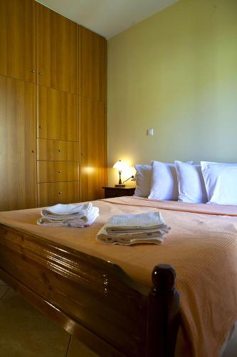 a bedroom with a bed with towels on it at Evangelia in Ayia Evfimia