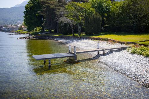 a bench sitting in the middle of a body of water at Cabana & Nuit de Château au bord du Lac Léman in Lugrin