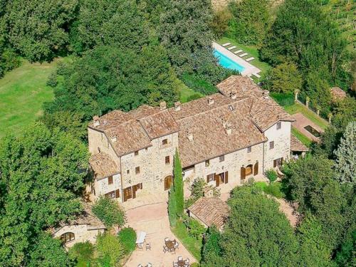 an aerial view of a large house with a pool at Unique country house in an old hamlet in Monte Castelli