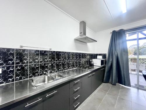 a kitchen with a sink and a counter top at The Grampians Motel in Halls Gap