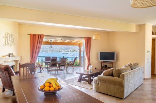 a living room with a couch and a table at Villa Pasithea in Korfos