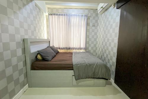 Tempat tidur dalam kamar di The Jarrdin Apartment by Tempat Singgah