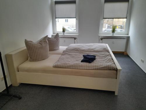 a bedroom with a bed with a hat on it at 70 qm Ferienwohnung mit 2 Schlafzimmern in Zwickau