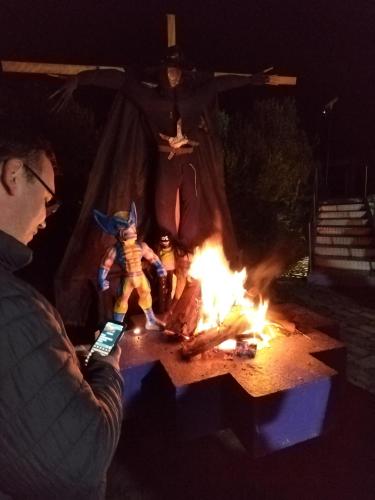 a man holding a cell phone next to a fire at Mamallacta Páramo Lodge in Papallacta