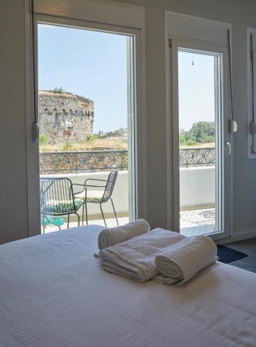 a bedroom with a bed and a view of a balcony at Kastron Views in Chios