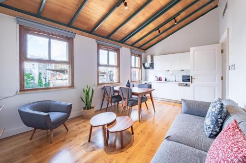 a living room with a couch and a table at Homie Suites - Historical Apartment Nearby Galata Tower in Istanbul