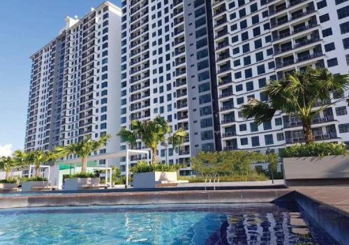a swimming pool in front of tall buildings at D Secret Homestay 2BR Condo Luxury in Johor Bahru