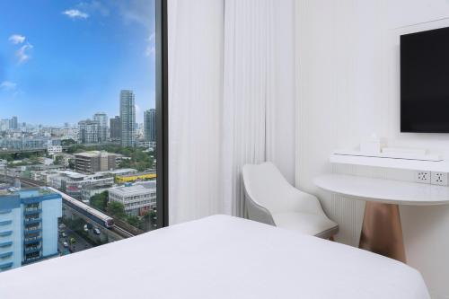 a white room with a view of a city at INNSiDE by Meliá Bangkok Sukhumvit in Bangkok