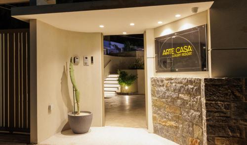 a entrance to a building with a plant in a vase at Arte Casa Luxury Resort in Prasás