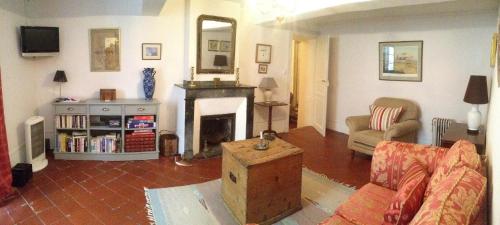 a living room with a couch and a fireplace at Maison Ville-Limoux in Limoux