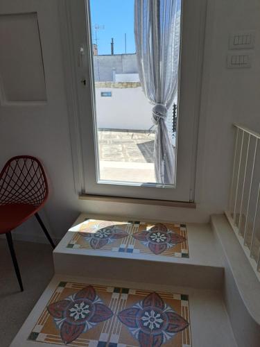 a small room with a window and a tile floor at Palazzo AD 1892 - SUITES & SPA in Ostuni