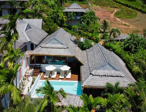 an aerial view of a house with a swimming pool and palm trees at Villa Vara - Tropical Pool Villa in Ao Nang Beach