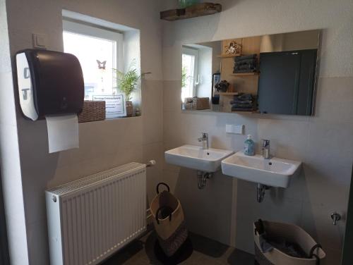 a bathroom with two sinks and a window at Fichtelpark in Kirchenlamitz