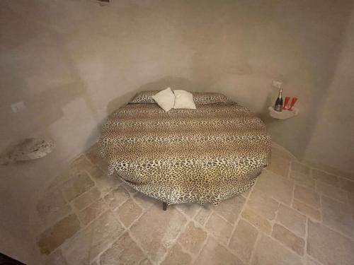 a bedroom with a bed with a leopard print at Villa Romina in Selva di Fasano
