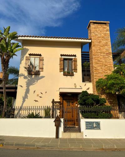 a white house with a door and a fence at Sotira Agia Napa Luxury House in Ayia Napa
