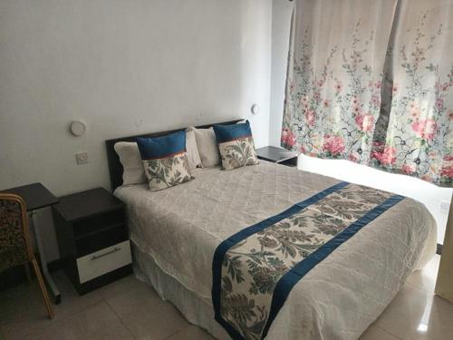 a bedroom with a bed and a window with curtains at MATT Bed and Breakfast in Lilongwe