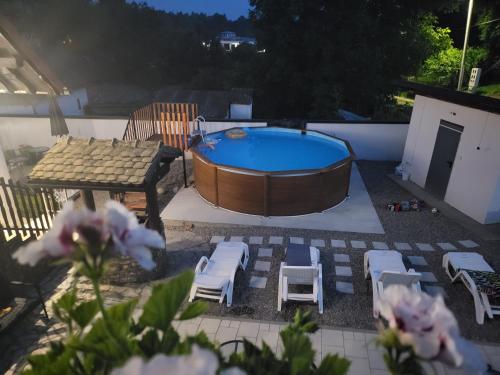 a backyard with a hot tub and chairs and a table at Vila Jovana in Vrdnik