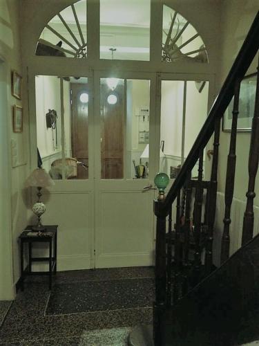 a room with a door and a staircase with a table at Maison Ville-Limoux in Limoux