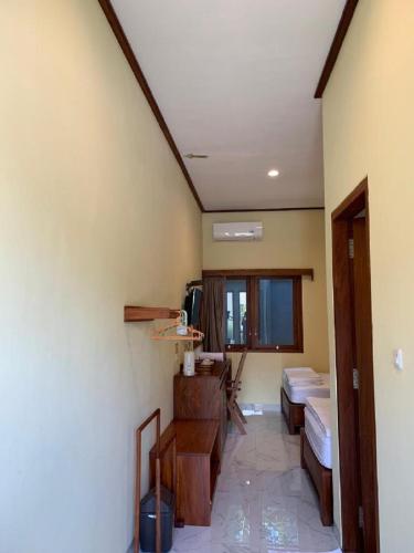 a hallway of a room with a room with two beds at Hotel & Villa Bukit Indah Saumlaki by LeGreen in Saumlaki