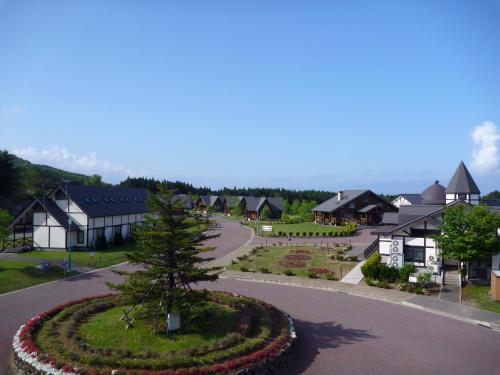 a small town with a garden in the middle of a road at Awone Shirakami Juniko in Fukaura