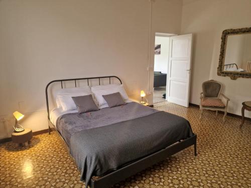 a bedroom with a bed and a chair and a mirror at FRANGI HOUSE in Pescara