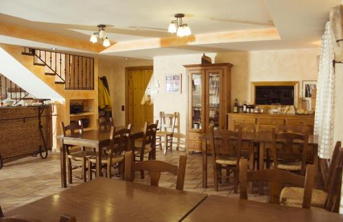 a dining room with wooden tables and chairs at Casa Rural Sierra Vicor in Sediles