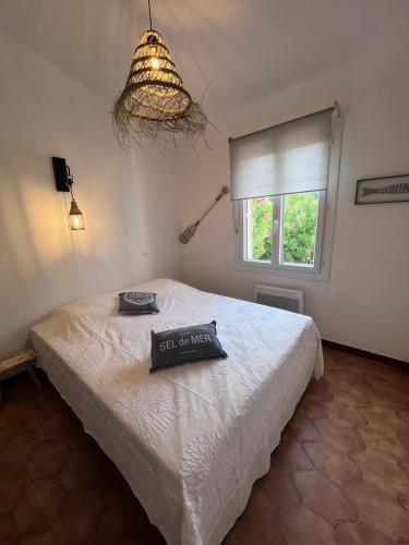 une chambre avec un lit avec un panneau dessus dans l'établissement Appartement avec piscine privée 4 à 6p 5min de la plage, à La Garonnette-Plage