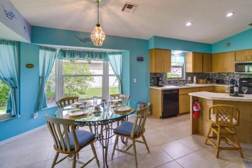 a kitchen with blue walls and a table and chairs at Pet-Friendly Sebastian Home with Porch and Lake View! in Sebastian