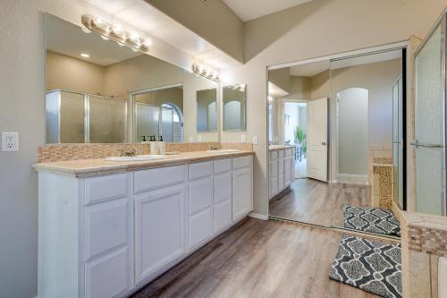 a bathroom with two sinks and a large mirror at Phoenix Home with Private Pool, 16 Mi to Downtown! in Phoenix