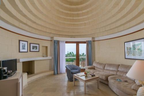 a living room with a couch and a table at Hotel Ta' Cenc & Spa in Sannat