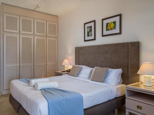 a bedroom with a large white bed with two lamps at Hotel Ta' Cenc & Spa in Sannat