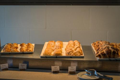 three trays of pastries on display in a bakery at Hotel Ta' Cenc & Spa in Sannat