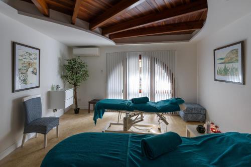 a bedroom with a bed and a table in a room at Hotel Ta' Cenc & Spa in Sannat