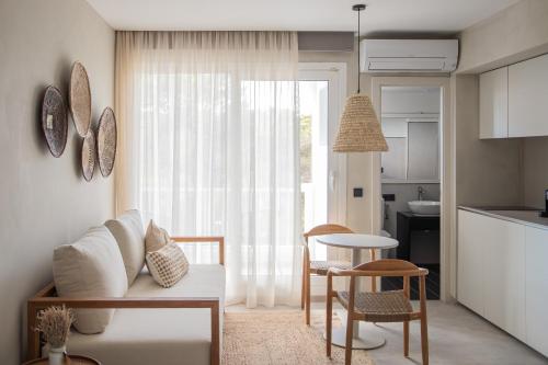 a living room with a couch and a table and a kitchen at Apartamentos Top Secret Es Pujols - Formentera Vacaciones in Es Pujols