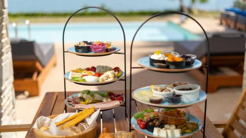 a three tiered tray of food on a table at Pamina Mare in Nea Skioni