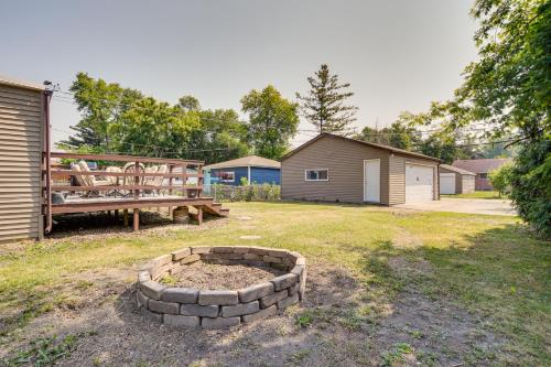 a backyard with a fire pit and a bench at Game Nights, BBQs and Family Fun Chicago Area Hub in Des Plaines