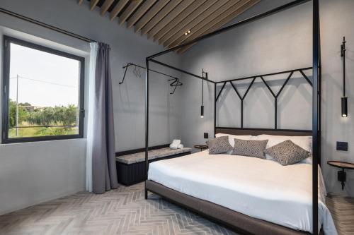 a bedroom with a large bed and a large window at Suite Fattore in San Gimignano