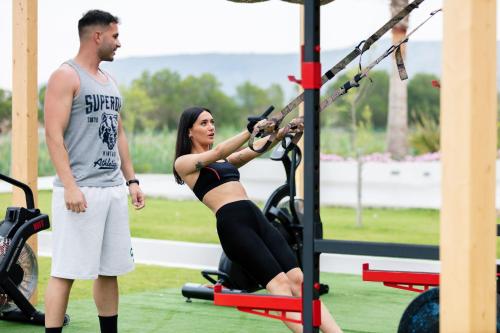 a man standing next to a woman in a gym at La Mer Resort Spa Crete in Georgioupolis