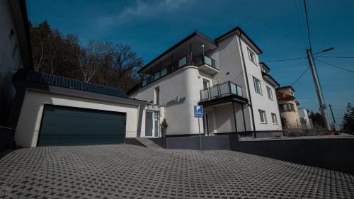 a large white house with a garage at PerfectSpa Wellness Apartment in Humenné