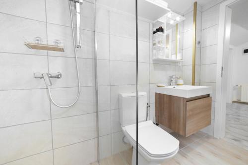 a bathroom with a toilet and a sink and a shower at PerfectSpa Wellness Apartment in Humenné