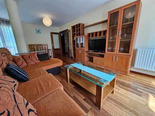 a living room with a couch and a coffee table at El Mirador de Llaneces 24A02 in Arenas de Cabrales