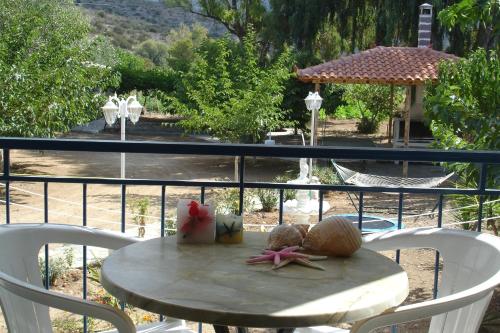 a table with shells on it on a balcony at Demos Studios in Kandia