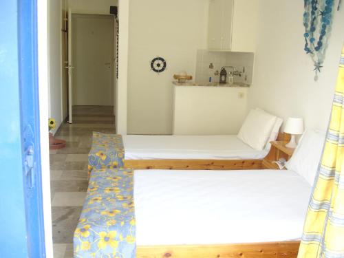 two beds in a small room with at Demos Studios in Kandia