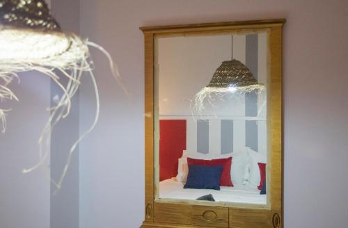 a mirror with a bed in a room at Luxury Singular Apartments in Santiago de Compostela