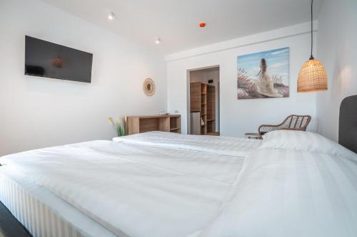 a white bedroom with a large white bed at SPOT Vama Veche in Vama Veche