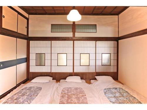 a bedroom with a large bed with two pillows at Higashiyama no Kobesso - Vacation STAY 14451 in Kitakyushu
